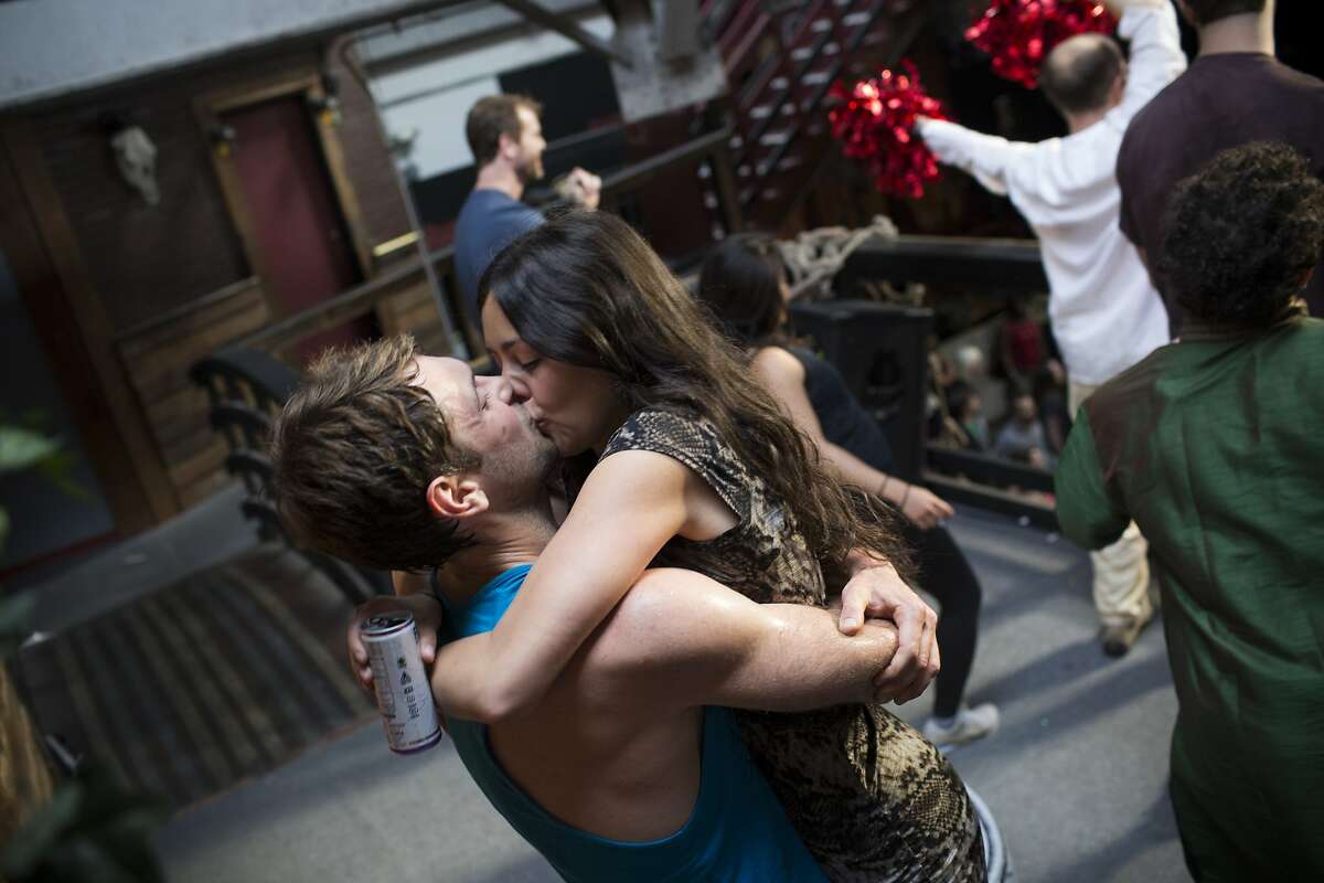 Paul McCloud kisses Ashley Ortega during Daybreaker, a device-free dance party hosted by Digital Detox and Camp Grounded, at Inner Mission in San Francisco, Calif. on Thursday, April 9, 2015.