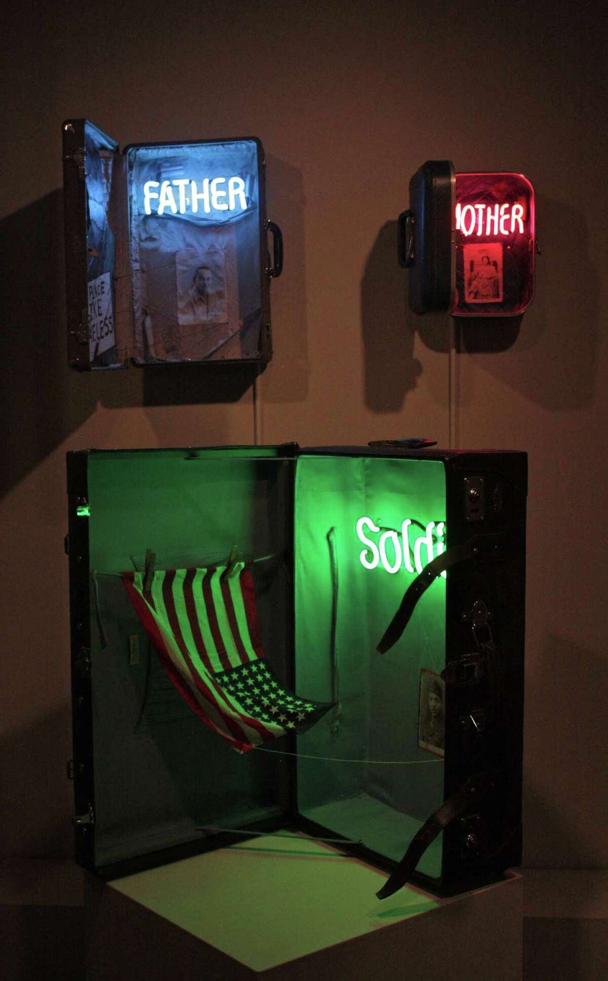 thacher 11 jpeg 3: William Rhodes' works "Patron Saint of Lost Causes," "Our Mother of Perpetual Lost Homes" and "Guardian of Forgotten Actions," made of suitcases neon glass, paint, thread and photographs, are on view at the Thacher Gallery. Courtesy Thacher Gallery.