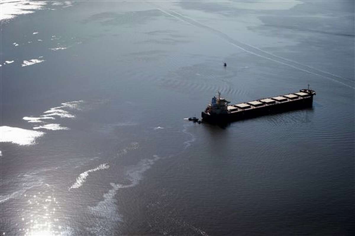 Fuel leaks from the bulk carrier cargo ship Marathassa, Thursday, April 9, 2015, in Vancouver, British Columbia. The City of Vancouver warned that the fuel is toxic and should not be touched. (AP Photo/The Canadian Press, Darryl Dyck)