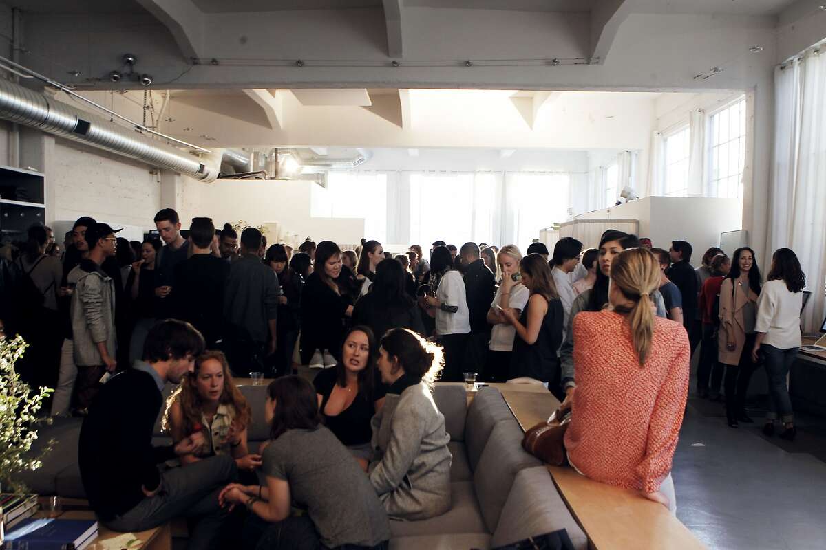 Customers socialize at the monthly open studio event at Everlane's office in San Francisco, Calif., Thursday April 9, 2015.