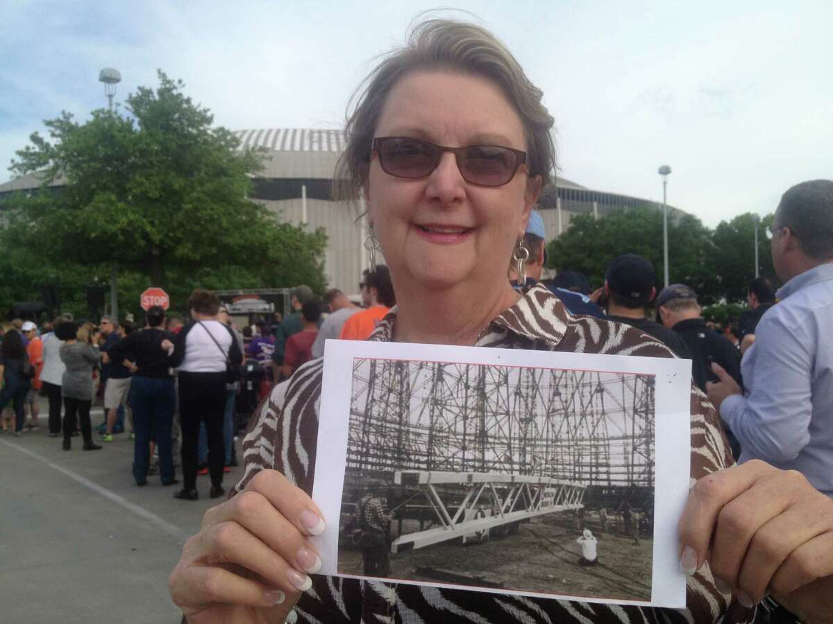 Connie Crabb Douglas holds a photo of her father building the Astrodome in 1963. He was an iron worker with the 84th Iron Workers' Union in Houston, and considered working on the dome among his greatest achievements. 