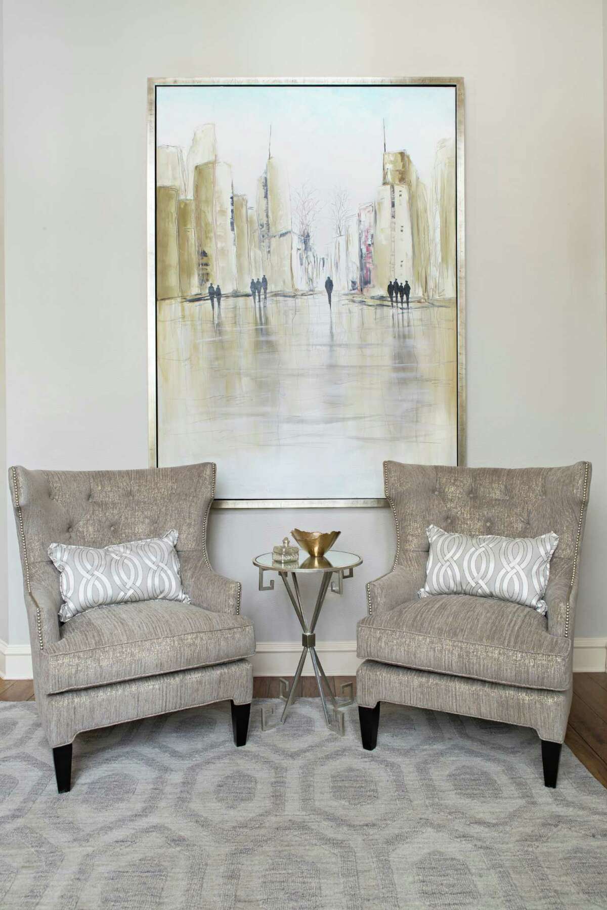 Behind the armchairs hangs a large painting Eck found in Dallas. The Liljas love New York City - it's where Jennifer was born - and they wanted to find a city scene that wouldn't darken the room.