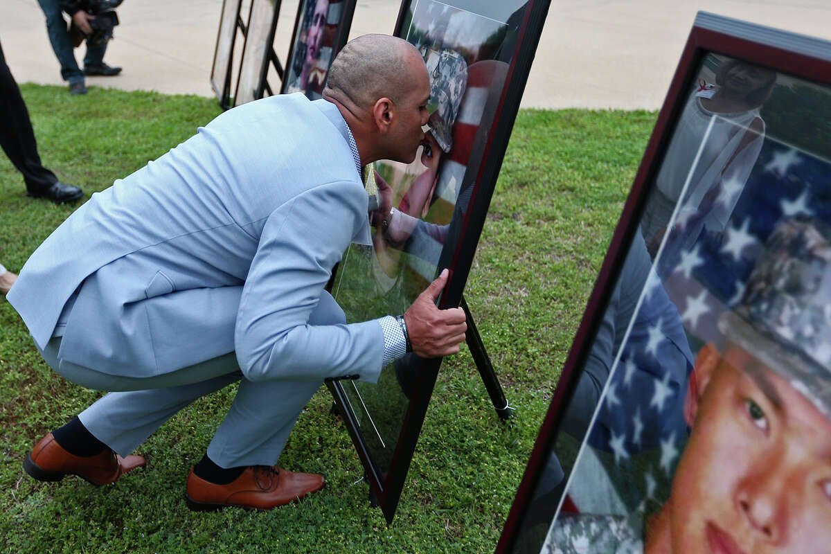 Juan Velez kisses a portrait of his daughter, PFC Francheska Velez before the Fort Hood Purple Heart and Defense of Freedom Medal Ceremony, Friday, April 10, 2015. The U.S. Army awarded Purple Hearts and the Defense of Freedom Medal to soldiers and civilians who were wounded or killed in the Nov. 5, 2009 massacre that left 13, dozen of them soldiers, dead and 31 injured. The attacker, Maj. Nidal Hasan, was convicted on August 2013.