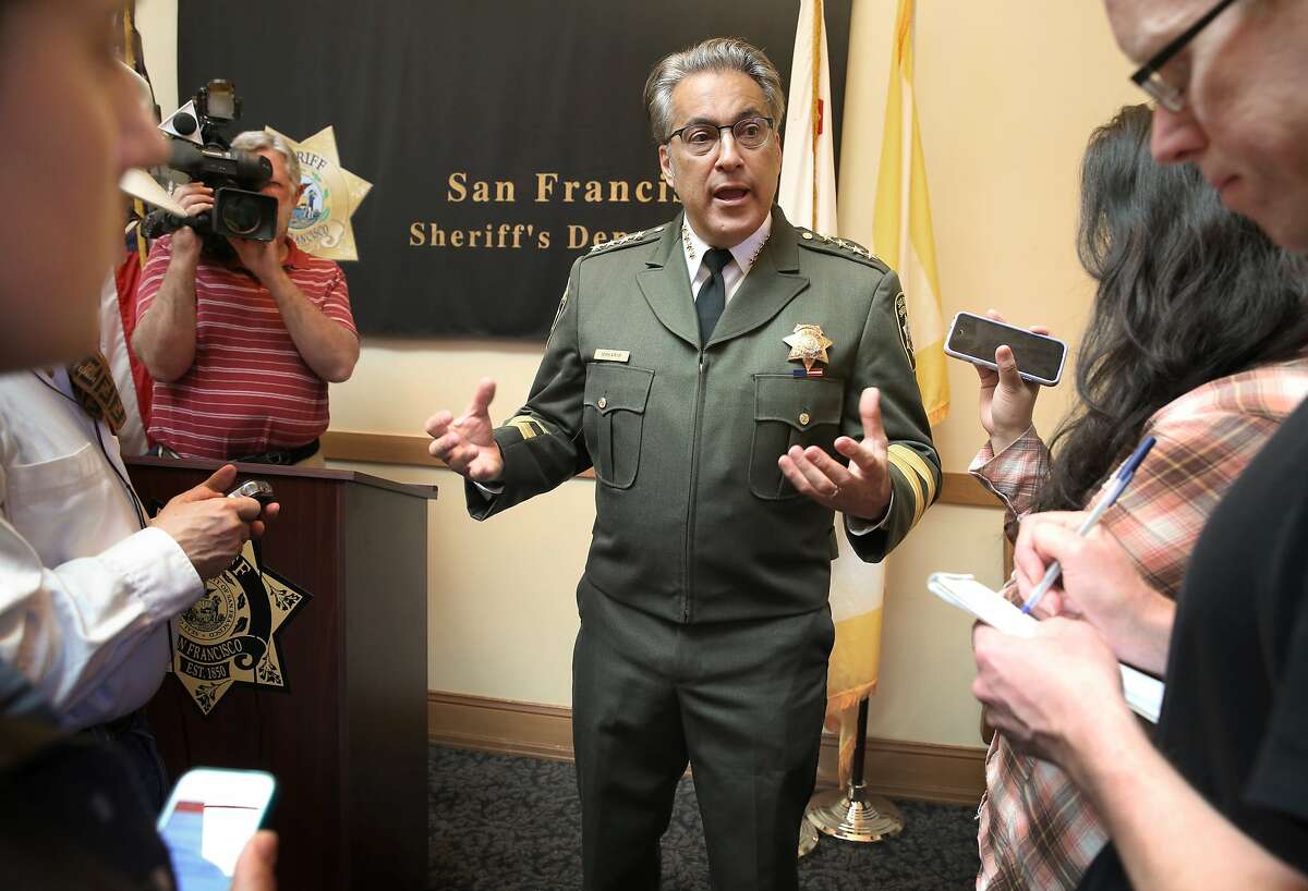 Sheriff Ross Mirkarimi (right) answers questions at a press conference regarding investigations on the recent inmate escape in his office at City Hall in San Francisco, California, on Friday, April 10, 2015.