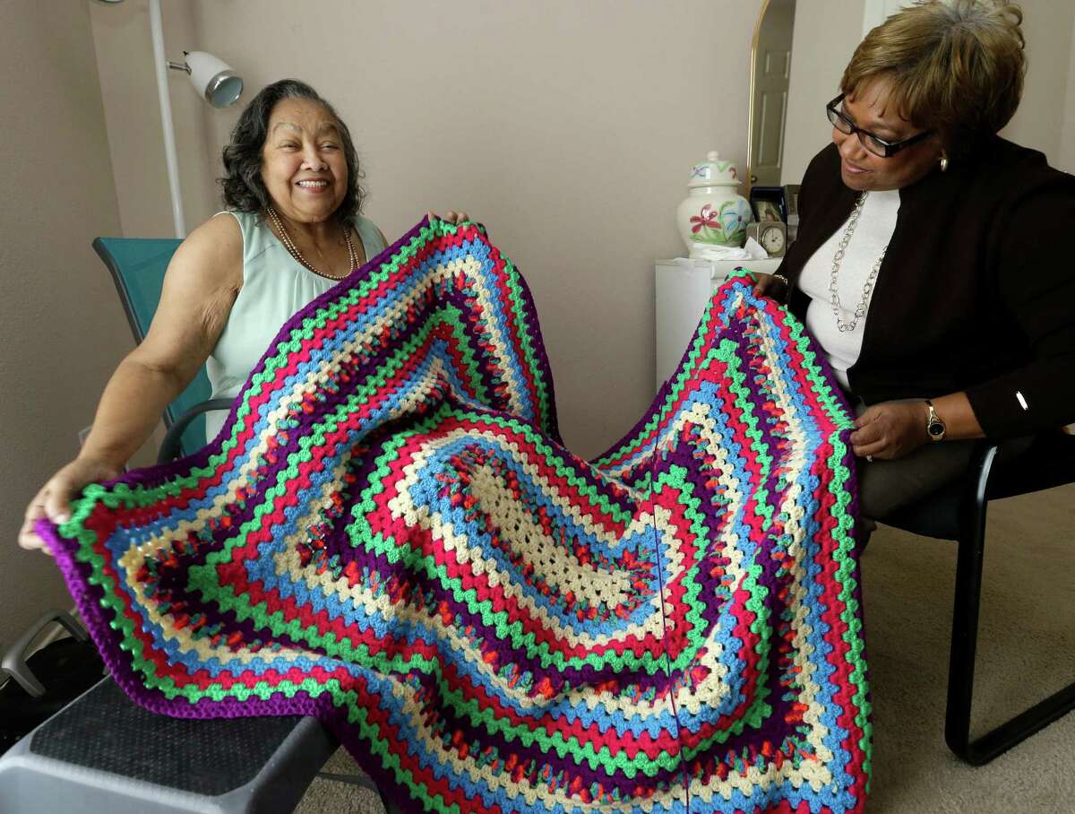 Odelia Wilson, 84, and her daughter, Deidre Hunter, talk about an afghan she is crocheting shown Wednesday, April 8, 2015, at her home in Richmond. Odelia is part of a patient follow up program with Houston Methodist. She was recently in the hospital for congestive heart failure. ( Melissa Phillip / Houston Chronicle )