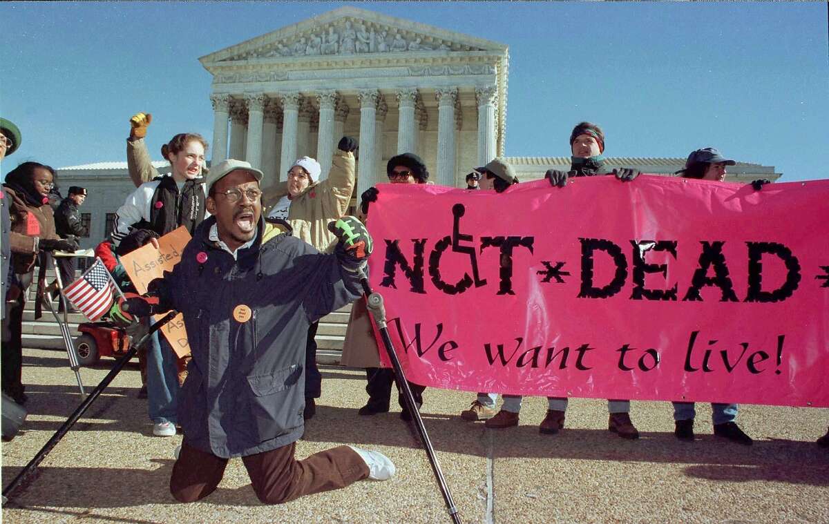 Gregory Dugan of Washington D.C. (L) leads a group of protestors against doctor-assisted suicide in front of the U.S. Supreme Court January 8, while inside the high court heard arguments on both sides of the right-to-die issue.