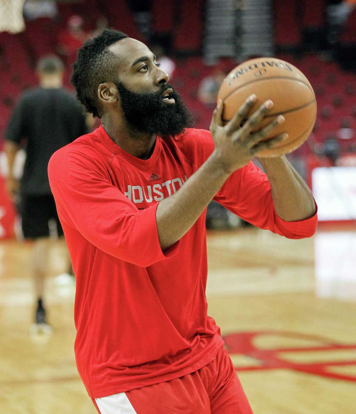 Houston Rockets' James Harden warms up before playing the San Antonio Spurs in an NBA basketball game Friday, April 10, 2015, in Houston.