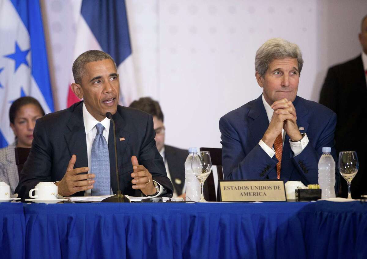 President Barack Obama, accompanied by Secretary of State John Kerry speaks during a multi-lateral meeting with Central American Integration System (SICA) Presidents, Friday, April 10, 2015, in Panama City, Panama. Obama is in Panama to attend the VII Summit of the Americas. (AP Photo/Pablo Martinez Monsivais) ORG XMIT: PANM127