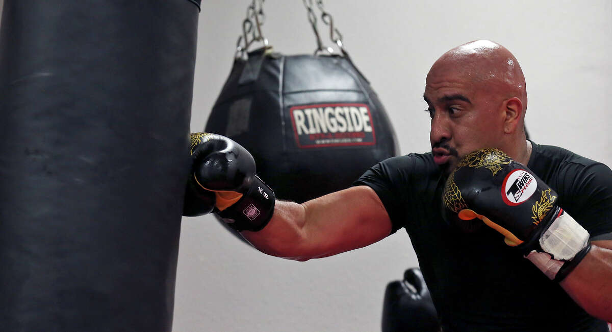 Alex Rincon, 35, hits the heavy bag during a Strike Fit class at Battle Tactics Academy.