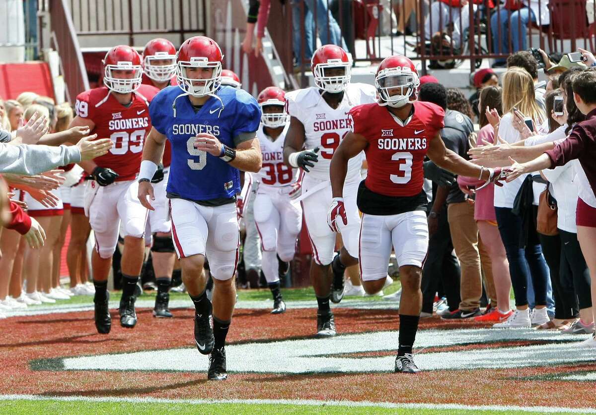 Oklahoma quarterback Trevor Knight (9) leads the team on the field before the start of the annual Red White spring college football scrimmage in Norman, Okla., Saturday, April 11, 2015.