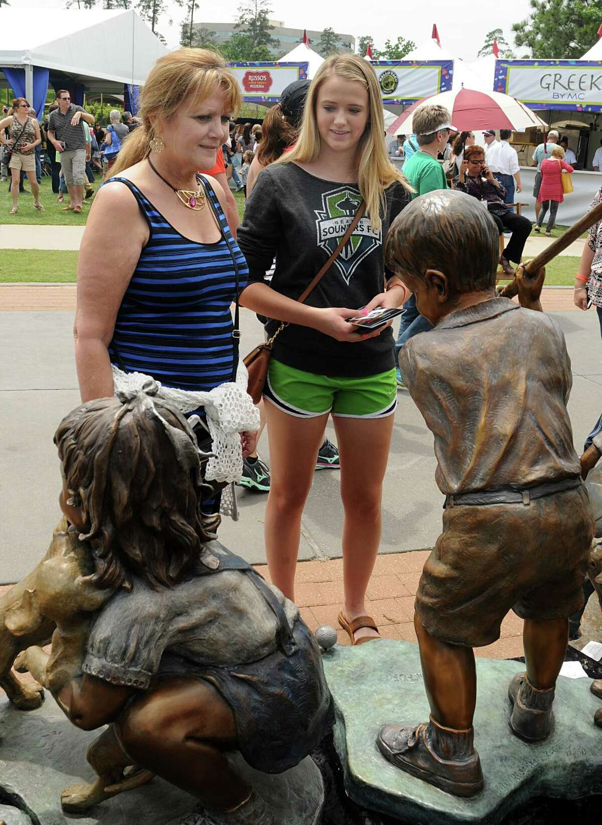 Sandy Eiland, of Tomball, and her granddaughter, Kendal Wuensche, of Tomball, admire bronze sculptures during the 10th annual The Woodlands Waterway Arts Festival on The Woodlands Waterway and Town Green Park. 200 artists from across the nation were featured at the festival. 