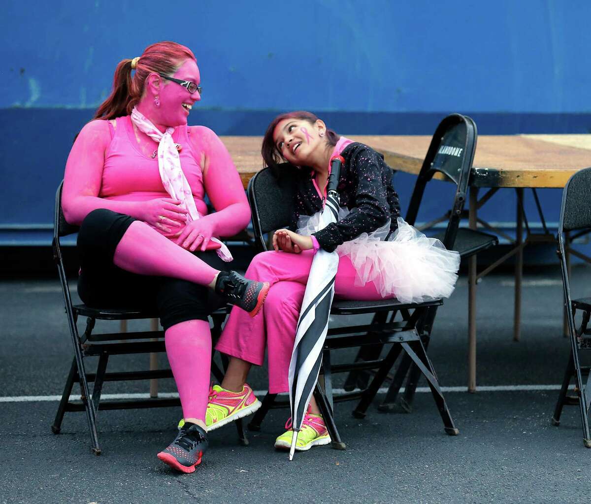 Judith Mares (left) goes all pink as she prepares to take part in the 18th annual Susan G. Komen Race For The Cure with her daughter, Xiomara, at the Alamodome on Saturday, Apr. 11, 2015. Mares participated in honor of her grandmother who is a cancer survivor. Thousands took part in the competitive and non-competitive 5K run and walk to raise cancer awareness.
