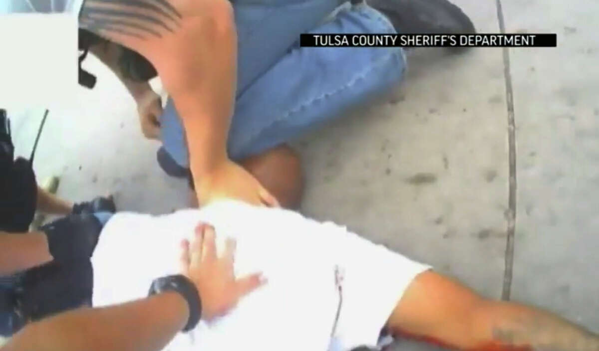 A video still shows police restraining Eric Courtney Harris before a reserve deputy yelled “Taser” and shot Harris dead.
