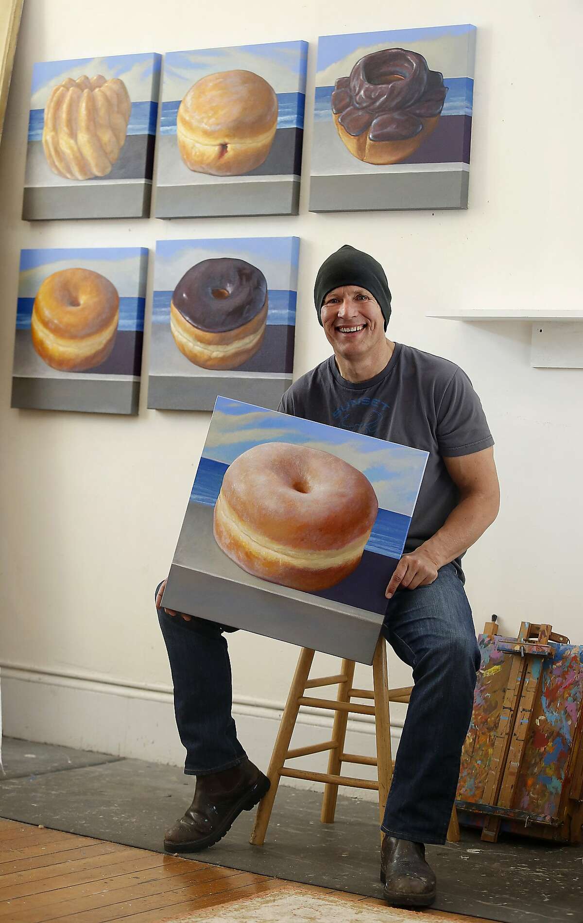 Still life painter Jay Mercado shows his donut portraits in San Francisco, California, on Friday, April 10, 2015. Genentech just bought six of them for its new headquarters building.