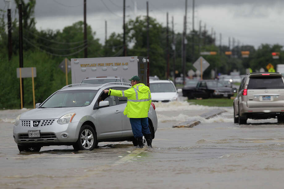 South Mayde Creek area (Katy)Cutter Urban, an oil and gas worker, helps police direct traffic out of high-water at the intersection of Greenhouse Road and Saums Road on Friday, Sept. 19, 2014, in Katy. The flooding was caused by South Mayde Creek overflowing from its banks. Photo: Mayra Beltran, Houston Chronicle File / © 2014 Houston Chronicle