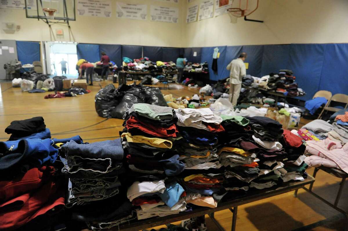 Volunteers at the Catholic Youth Organization sort through clothing, toys, food and other items on Monday, April 13, 2015, in Troy, N.Y. People have been donating items for those who lost their homes in the fire last week on Washington St. and Fourth St. in the city. (Paul Buckowski / Times Union)