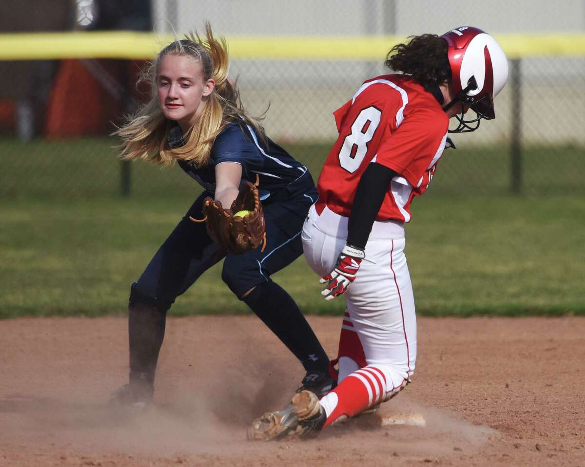 Wilton second baseman Emma Cropper, left, attempts to tag out Greenwich baserunner Sam Scordo in Greenwich's 7-5 win over Wilton in the high school softball game at Greenwich High School in Greenwich, Conn. Monday, April 13, 2015.