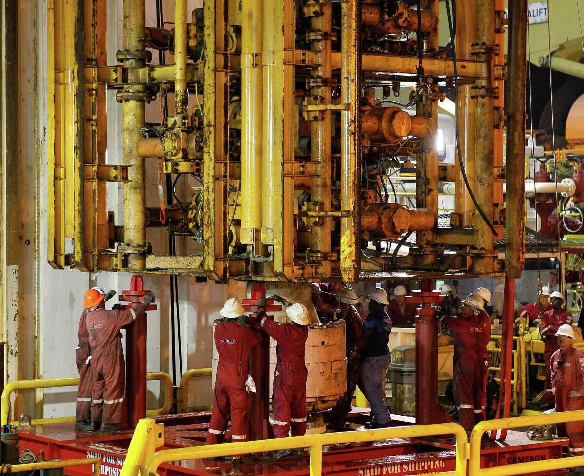 Workers secure the Deepwater Horizon's blowout preventer ﻿after lifting it from the Gulf of Mexico in September 2010. Investigations into the 2010 spill disaster found flaws in the devices' design.