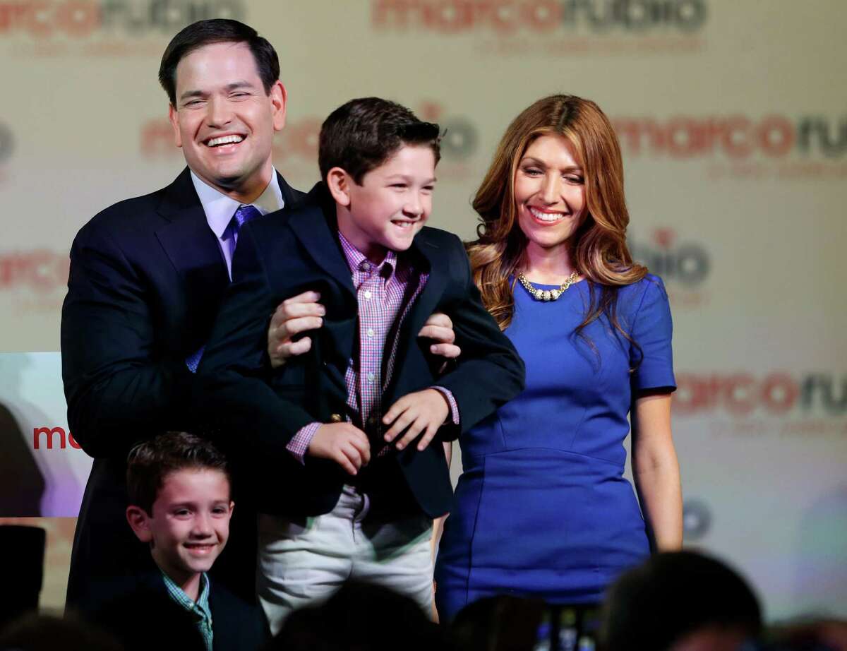 Florida Sen. Marco Rubio smiles onstage after his announce-ment on Monday in Miami with his family, sons Dominic, from left, ﻿and Anthony,﻿ and his wife, Jeanette﻿.