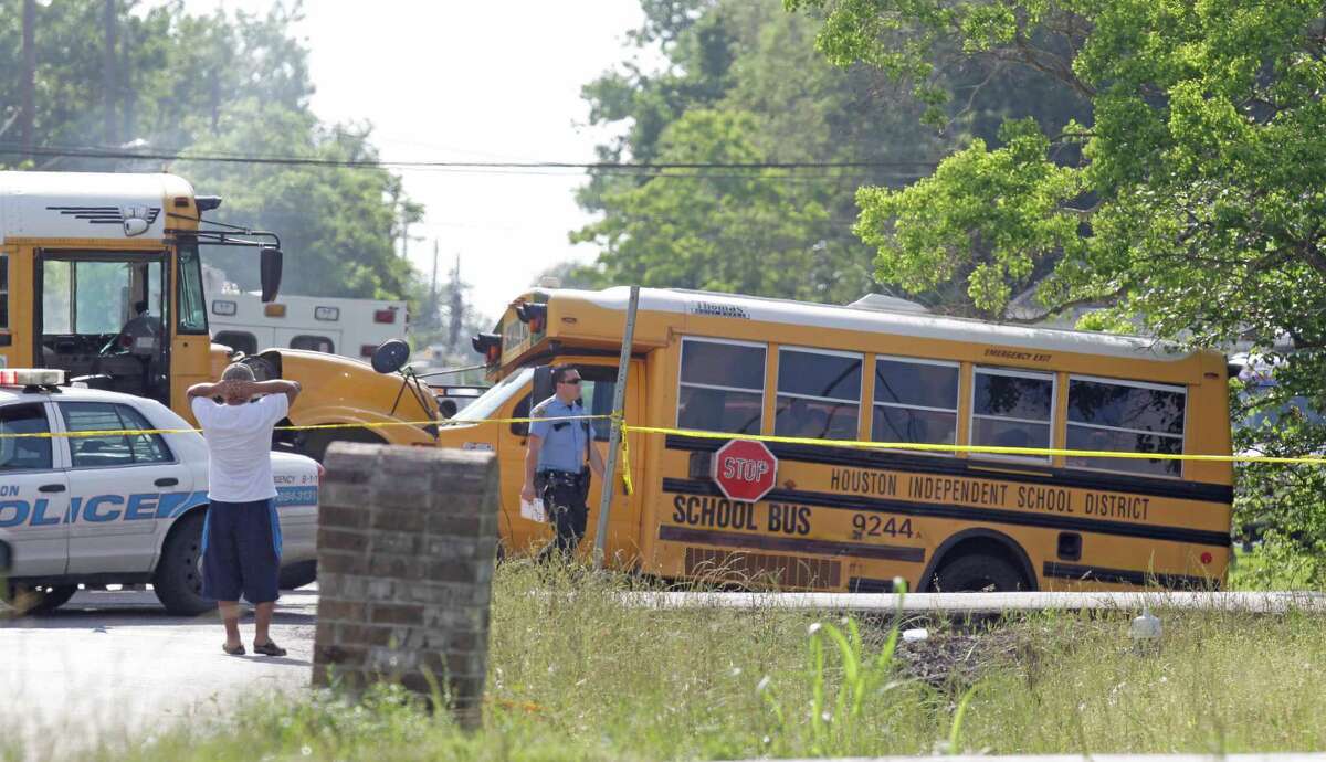 Police and emergency personnel are shown at the scene where two Houston ISD school buses collided at the corner of Bacher and Bonaire Monday, April 13, 2015. The buses originated from nearby Elmore and Burrus elementary schools. ( Melissa Phillip / Houston Chronicle )