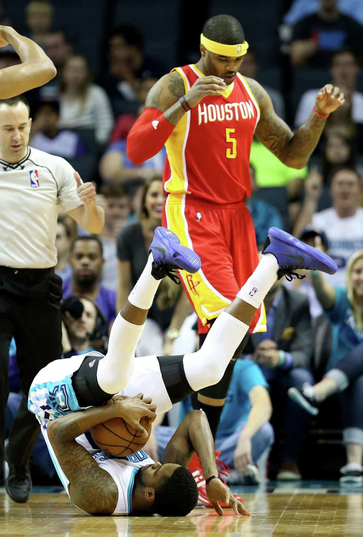 CHARLOTTE, NC - APRIL 13: Josh Smith #5 of the Houston Rockets watches as Troy Daniels #30 of the Charlotte Hornets falls back after a play during their game at Time Warner Cable Arena on April 13, 2015 in Charlotte, North Carolina. NOTE TO USER: User expressly acknowledges and agrees that, by downloading and or using this photograph, User is consenting to the terms and conditions of the Getty Images License Agreement. (Photo by Streeter Lecka/Getty Images)