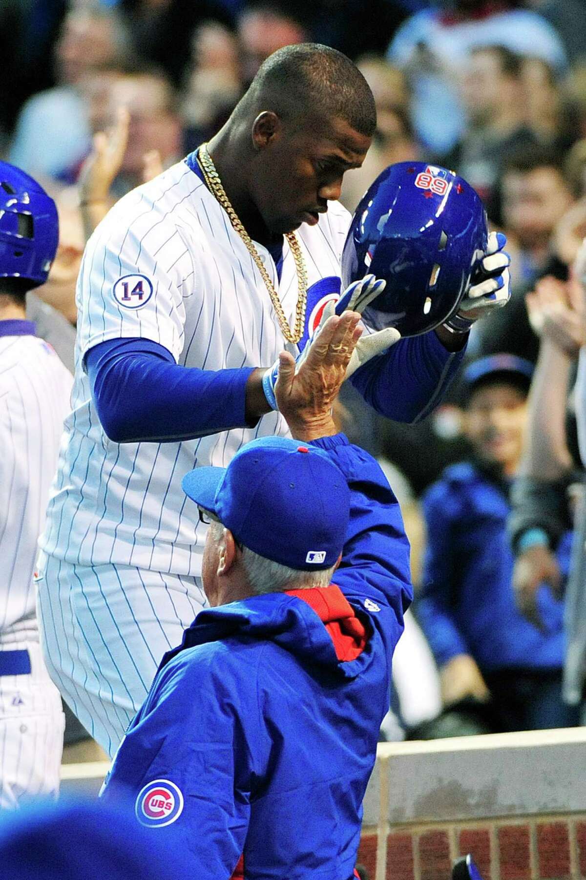 The Cubs' Jorge Soler, top, receives a high-five from manager Joe Maddon after hitting the first of a pair of two-run homers Monday night.