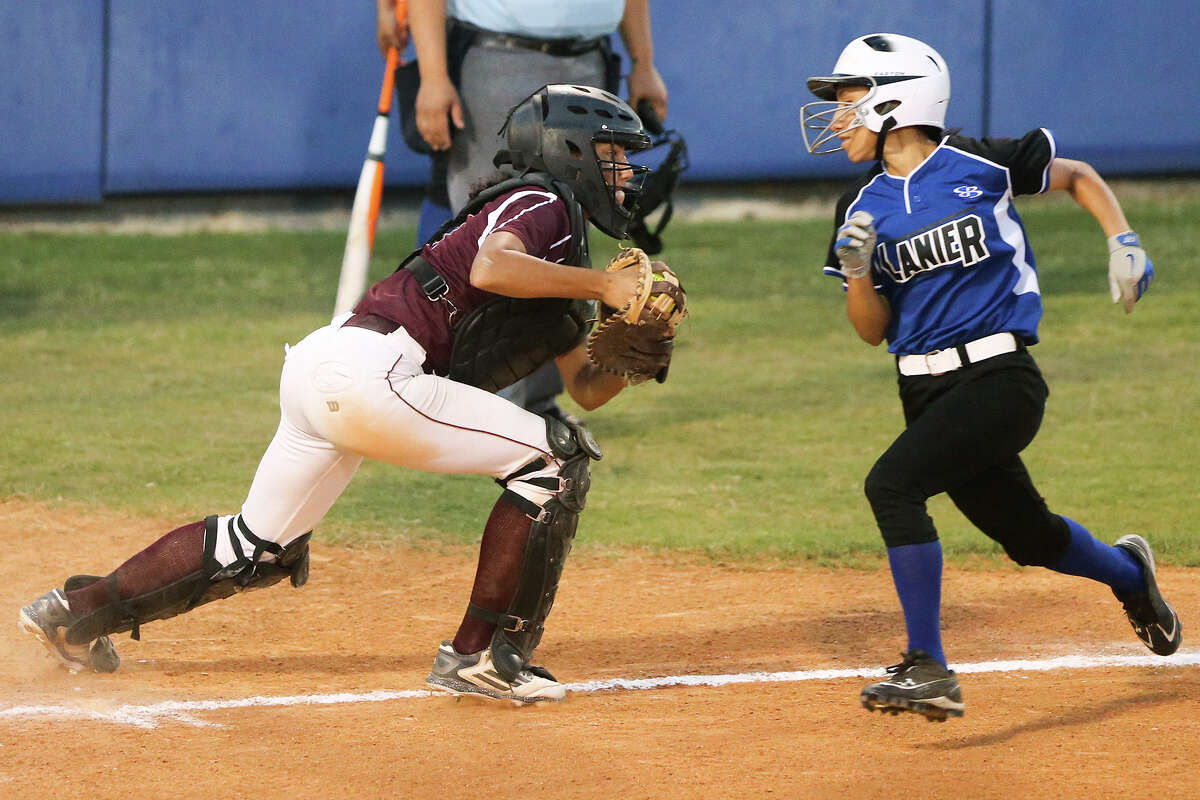 Highlands' Jenelle Rodriguez (left) tries to keep Lanier's Esmi Garza from scoring during the second inning of their game at the Mary Ann Villarreal Sports Complex on Tuesday, April 7, 2015. Highlands outscored Lanier 24-9 in the last three innings to beat the Lady Voks 34-26. MARVIN PFEIFFER/ mpfeiffer@express-news.net