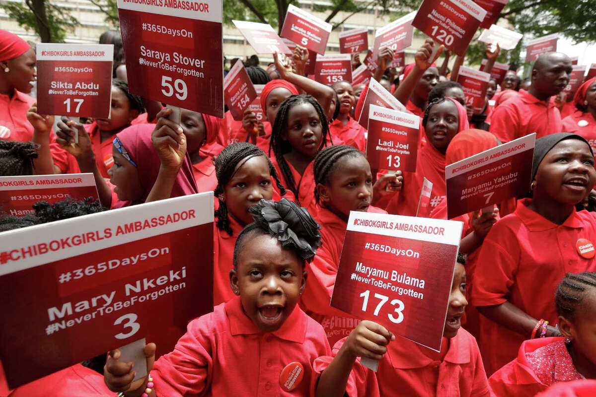 Young girls known as Chibok Ambassadors, carry placards bearing the names of the girls kidnapped from the government secondary school in Chibok, a year ago, during a demonstration, in Abuja, Nigeria, Tuesday, April 14, 2015. Never to be forgotten. The new slogan adopted Tuesday is a sad concession that many believe few of the Chibok girls kidnapped one year ago by Islamic extremists will ever find their way home. On the first anniversary of the day 276 schoolgirls were snatched in the middle of the night as they prepared to write science exams at their boarding school in northeastern Nigeria, President-elect Muhammadu Buhari said he cannot promise to find the 219 who are still missing. (AP Photo/Sunday Alamba)
