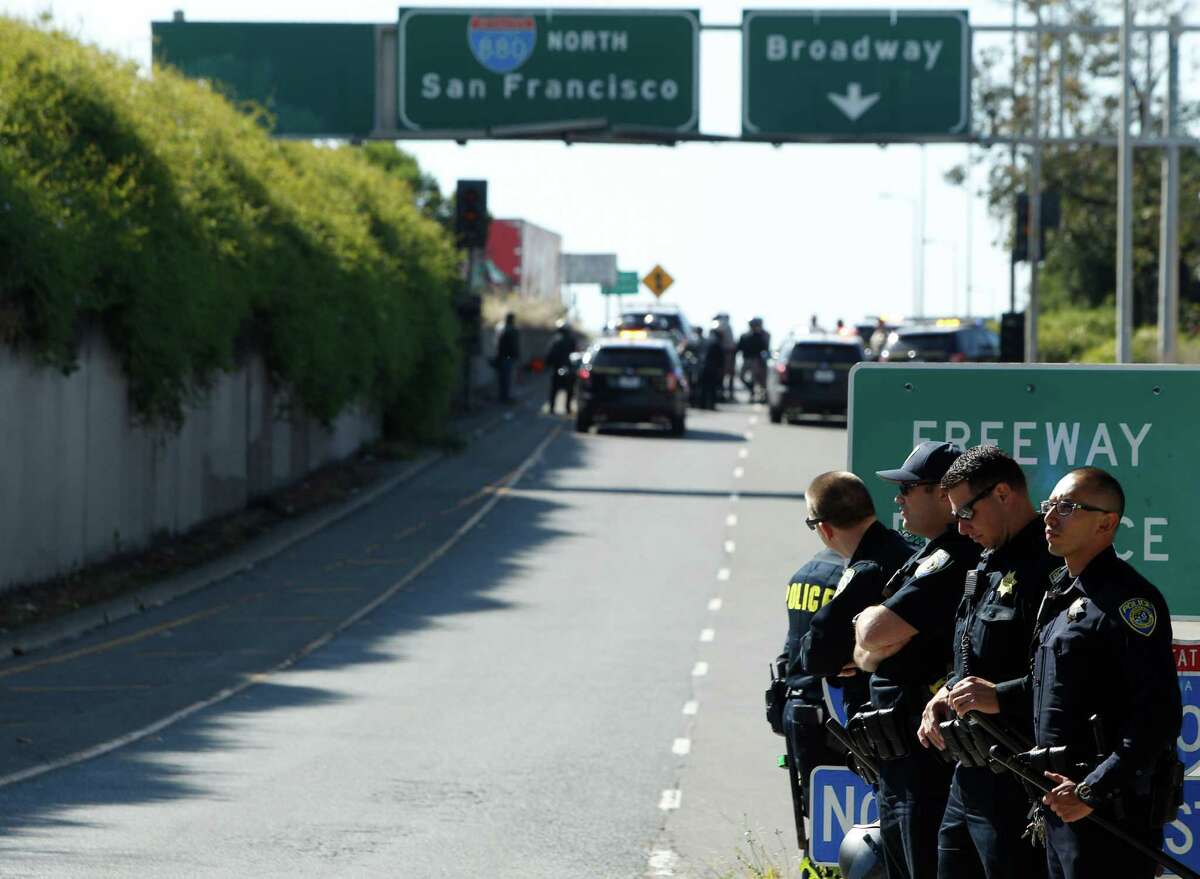 CHP, BART and Oakland police officers block the Jackson Street freeway entrance after demonstrators stormed onto the freeway for a protest against police, Tuesday, April 14, 2015, in Oakland, Calif.