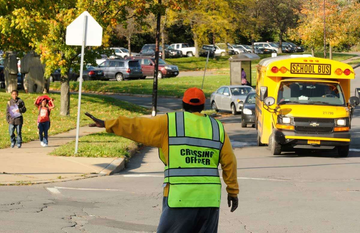 Delores Traynham an Albany school crossing guard for 11-years works the corner of Arbor and Lark Drives near Arbor Hill Elementary School in Albany, NY Thursday, Oct. 20, 2011.( Michael P. Farrell/Times Union) ORG XMIT: MER2015041415590917