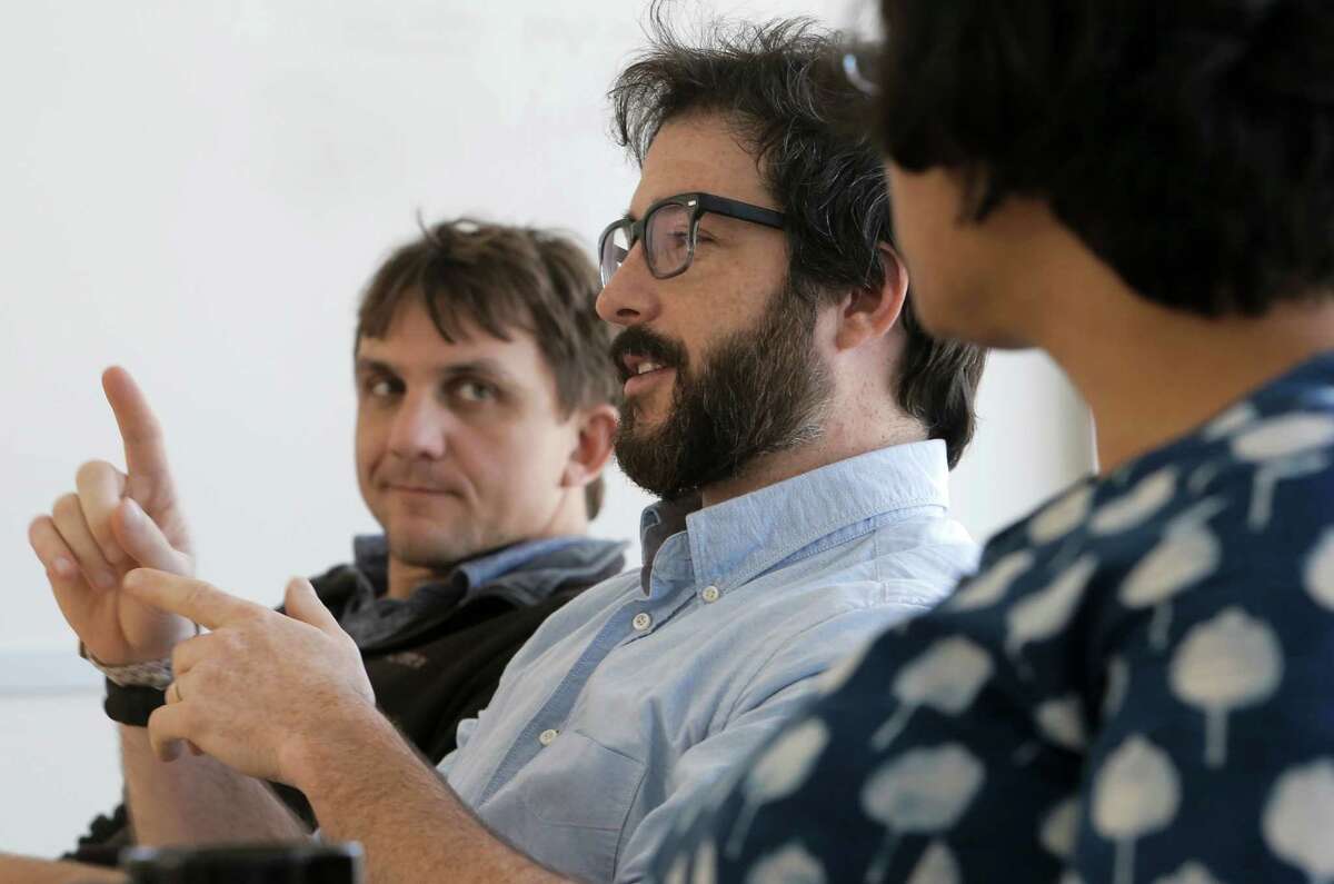 Postdoctoral student Daniel Horton, (left) and Deepti Singh, (right) a graduate student listens to remarks by Justin Mankin, (center) a graduate student during a lab meeting at Stanford University in Palo Alto, Calif. on Tues. April 14, 2015.
