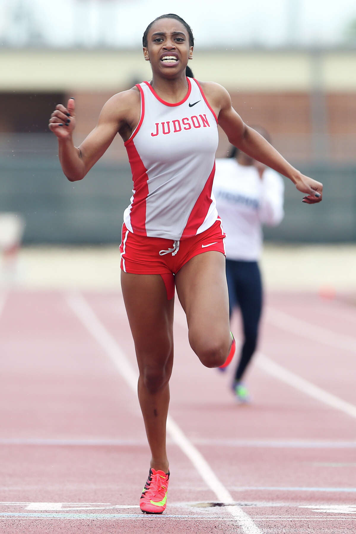 Judson’s Kiana Horton crosses the finish line of the 200-meter dash during Judson’s Ron Faught Invitational at Rutledge Stadium on March 21, 2015. Horton won the event with a time of 23.56 seconds and was named top female athlete of the meet.