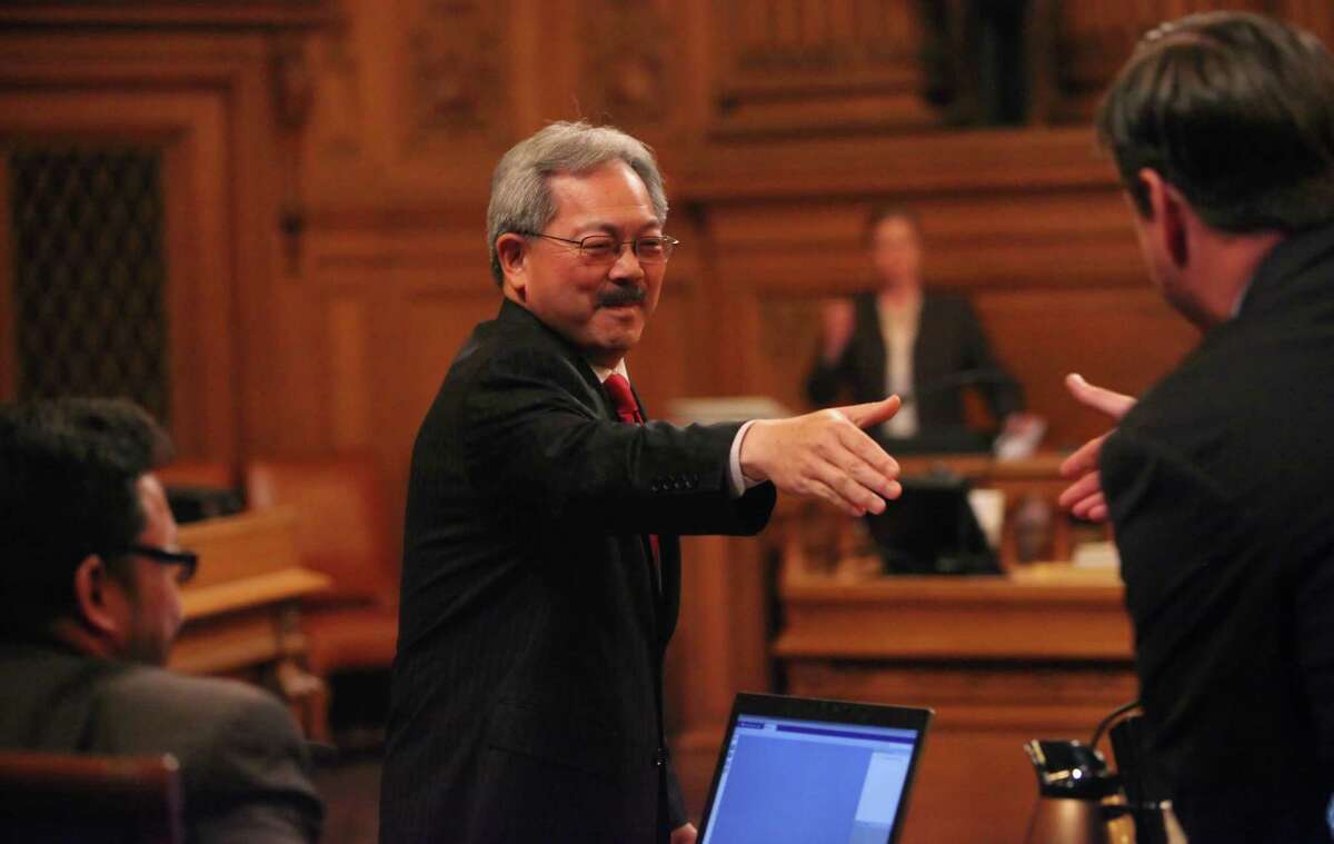 San Francisco Mayor Ed Lee (center) shakes hands with Supervisor Mark Farrell before answering questions from the Board of Supervisors during policy discussions about the proposed Airbnb ordinance at City Hall in 2011.