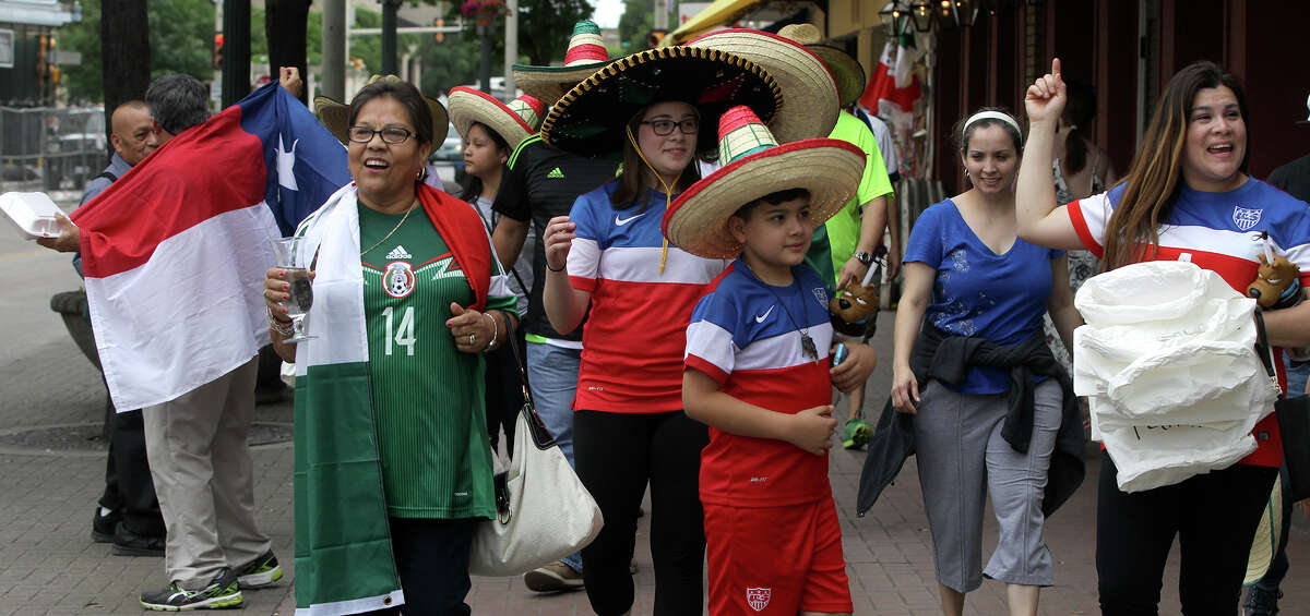Soccer fans walk in Alamo Plaza Wednesday April 15, 2015 in anticipation of the match between the United States and Mexico's men's national soccer teams to be held at the Alamodome.