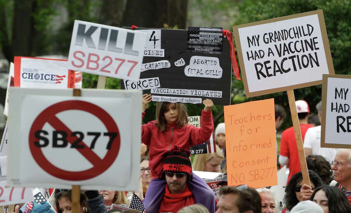 In this April 8, 2015 file photo, protesters rally against a measure requiring California schoolchildren to get vaccinated at the Capitol in Sacramento, Calif. Senate Bill 277, a California bill that would sharply limit vaccination waivers after a Disneyland measles outbreak, has generated such an acidic debate that Sen. Richard Pan, the proposal's author, was under added security this week. (AP Photo/Rich Pedroncelli, file)