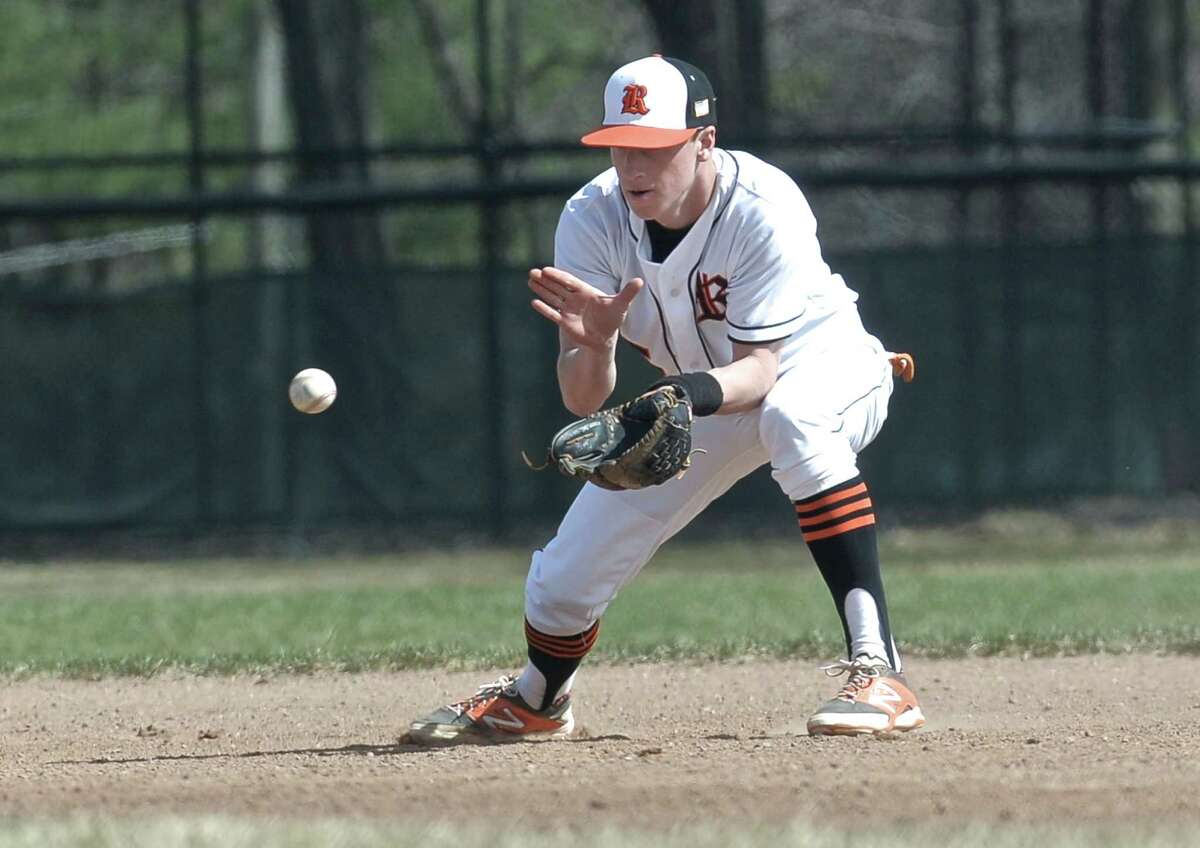 Ridgefield's John Stamatis (5) fields a well hit grounder and makes the throw to first for the out during the boys high school baseball game between Harding and Ridgefield high schools, played at Ciuccoli Field in Ridgefield, Conn, on Wednesday, April 15, 2015.
