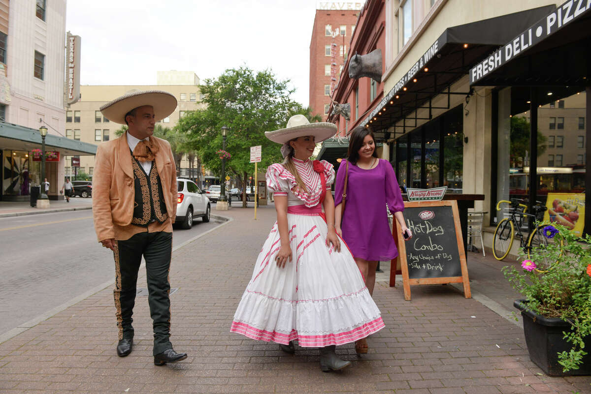 Deposed Charro Queen Gabriela Gonzalez arrives for the Hispanic Heritage Center of Texas Annual Fiesta Kickoff at the Buckhorn Saloon Wednesday evening with her father, Robert Gonzalez (left) and friend Andrea Quintana.