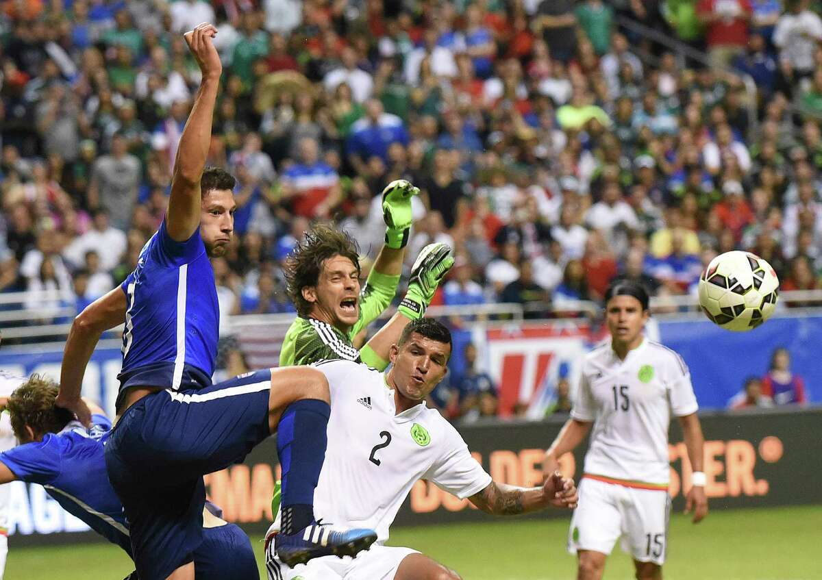 Omar Gonzalez of the USA left, battles Mexico's Francisco Rodriguez (2) near the goal during an international friendly match at the Alamodome on Wednesday, April 15, 2015.