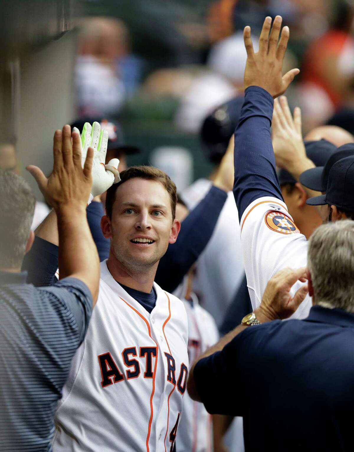 Houston Astros' Jed Lowrie is congratulated after hitting a two-run home run against the Oakland Athletics during the first inning of a baseball game Wednesday, April 15, 2015, in Houston. (AP Photo/Pat Sullivan)