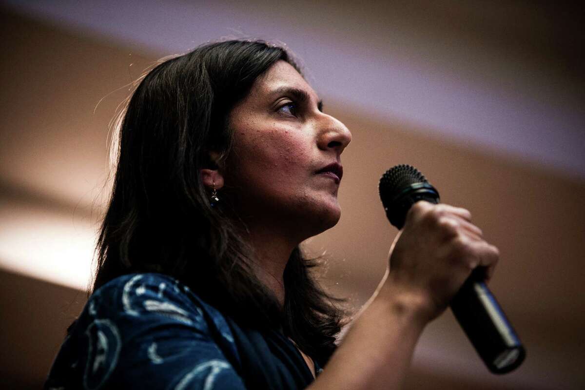 Seattle City Council member Kshama Sawant, left, speaks as hundreds of workers and students alike packed into Seattle University to rally together as part of the national mobilization in the movement against poverty-wage jobs.