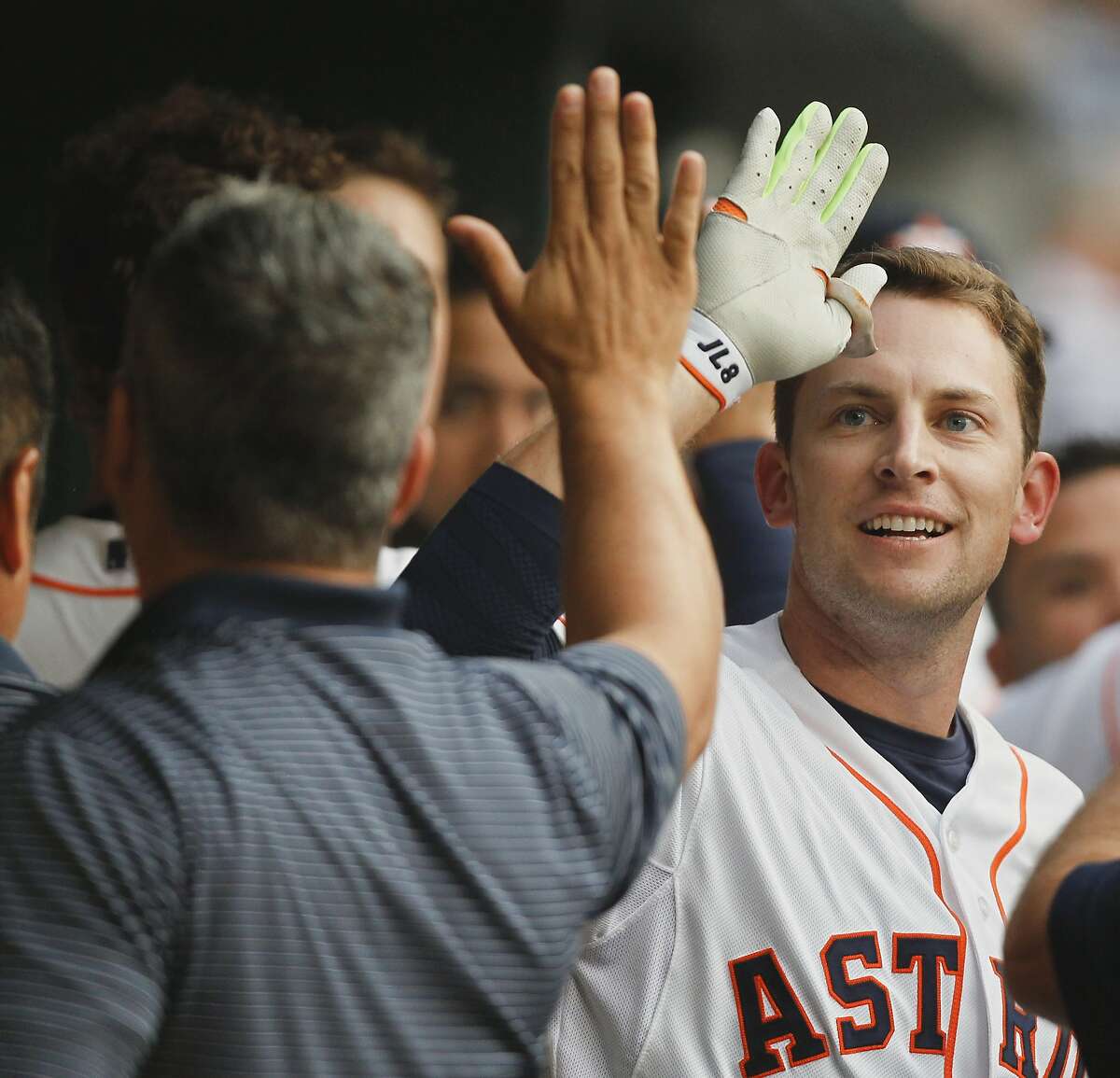 HOUSTON, TX - APRIL 15: Jed Lowrie of the Houston Astros receives congratulations from the dugout after hitting a home run in the first inning against the Oakland Athletics at Minute Maid Park on April 15, 2015 in Houston, Texas. All Major League Baseball players are wearing #42 today in honor of Jackie Robinson Day. (Photo by Bob Levey/Getty Images)