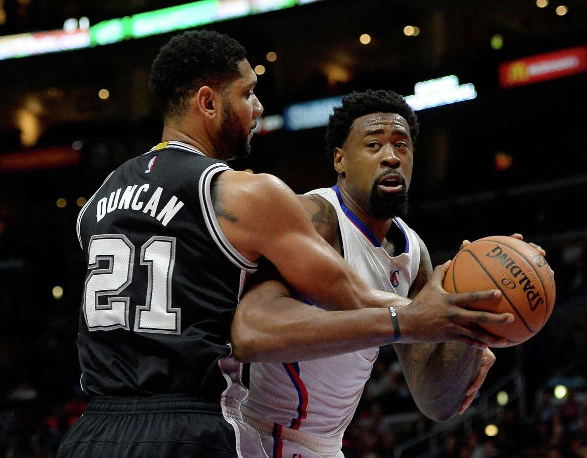 The Clippers’ DeAndre Jordan is fouled by the Spurs’ Tim Duncan at Staples Center on Feb. 19, 2015, in Los Angeles.