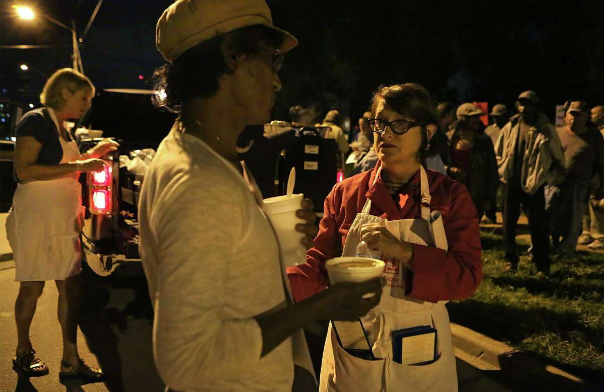 Joan Cheever, right, was given a ticket by San Antonio Police on April 7, for serving food without a proper permit in Maverick Park. The following week, April 14, Cheever showed up again to feed the homeless as she does every Tuesday night, but this time she was joined by more than 50 supporters.