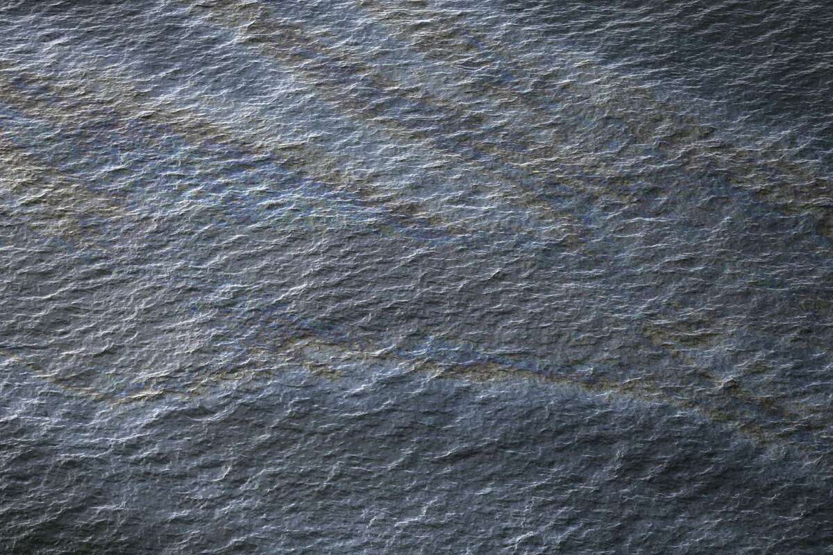 This March 31, 2015 photo shows an oil sheen drifting from the site of the former Taylor Energy oil rig in the Gulf of Mexico, off the coast of Louisiana. (AP Photo/Gerald Herbert)