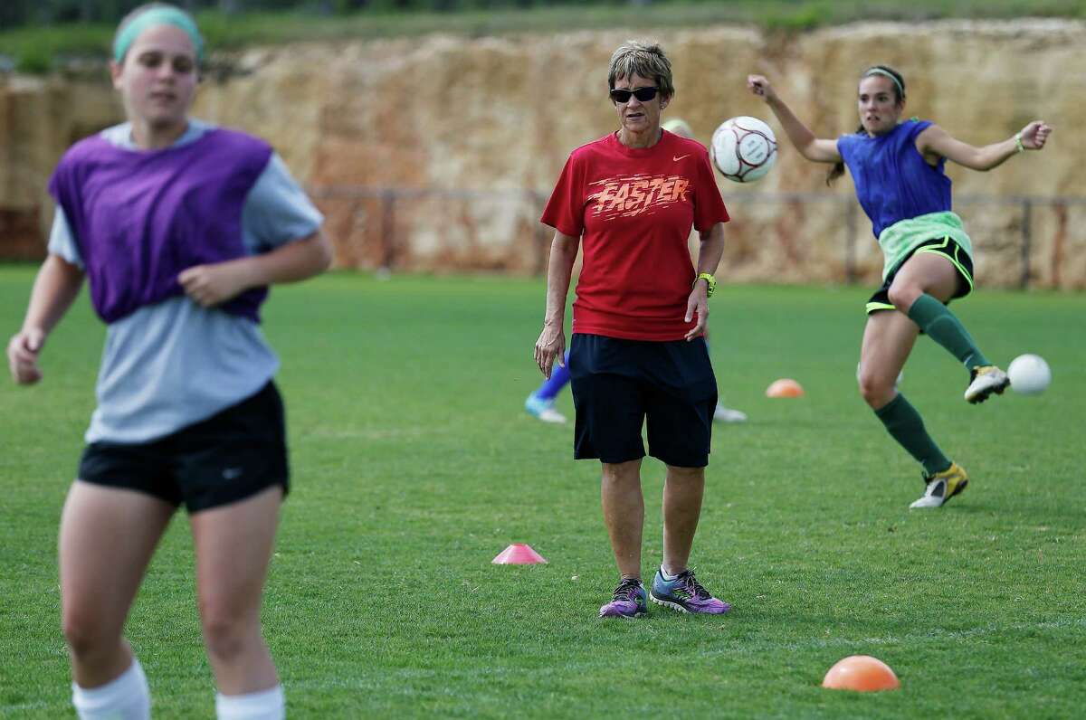 Reagan girls soccer coach Frankie Whitlock (center) oversees practice with her team on April 14, 2015.