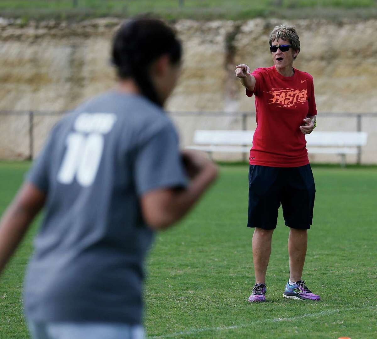 Reagan girls soccer coach Frankie Whitlock (right) oversees practice with her team on Tuesday, Apr. 14, 2015. The team’s formidable group of reserve players have helped Reagan reach the state tournament.
