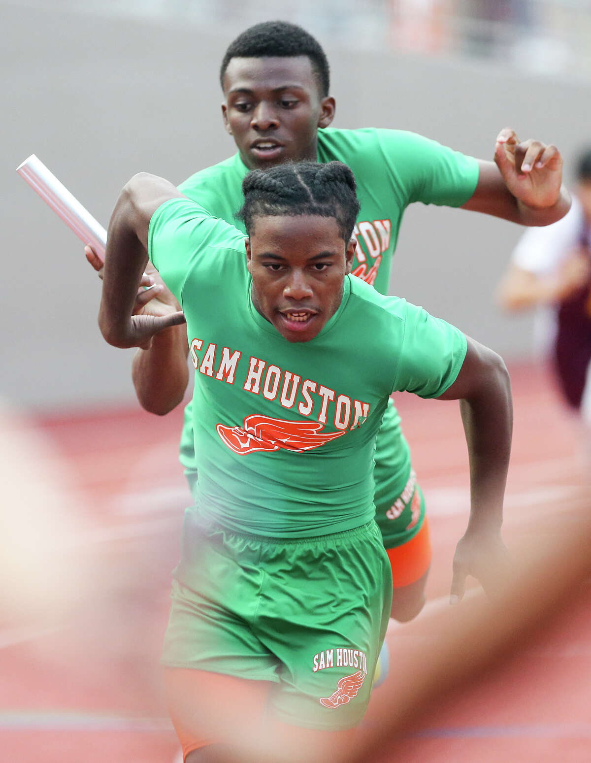Sam Houston's Ka'Shiek Walker prepares to take the baton from Willie Debrow on the third leg of the 800-meter relay during the finals of the running events in the District 28-5A track and field meet at Alamo Stadium on Thursday, April 16, 2015. Sam Houston won the event with a time of 1 minute, 32.63 seconds. MARVIN PFEIFFER/ mpfeiffer@express-news.net