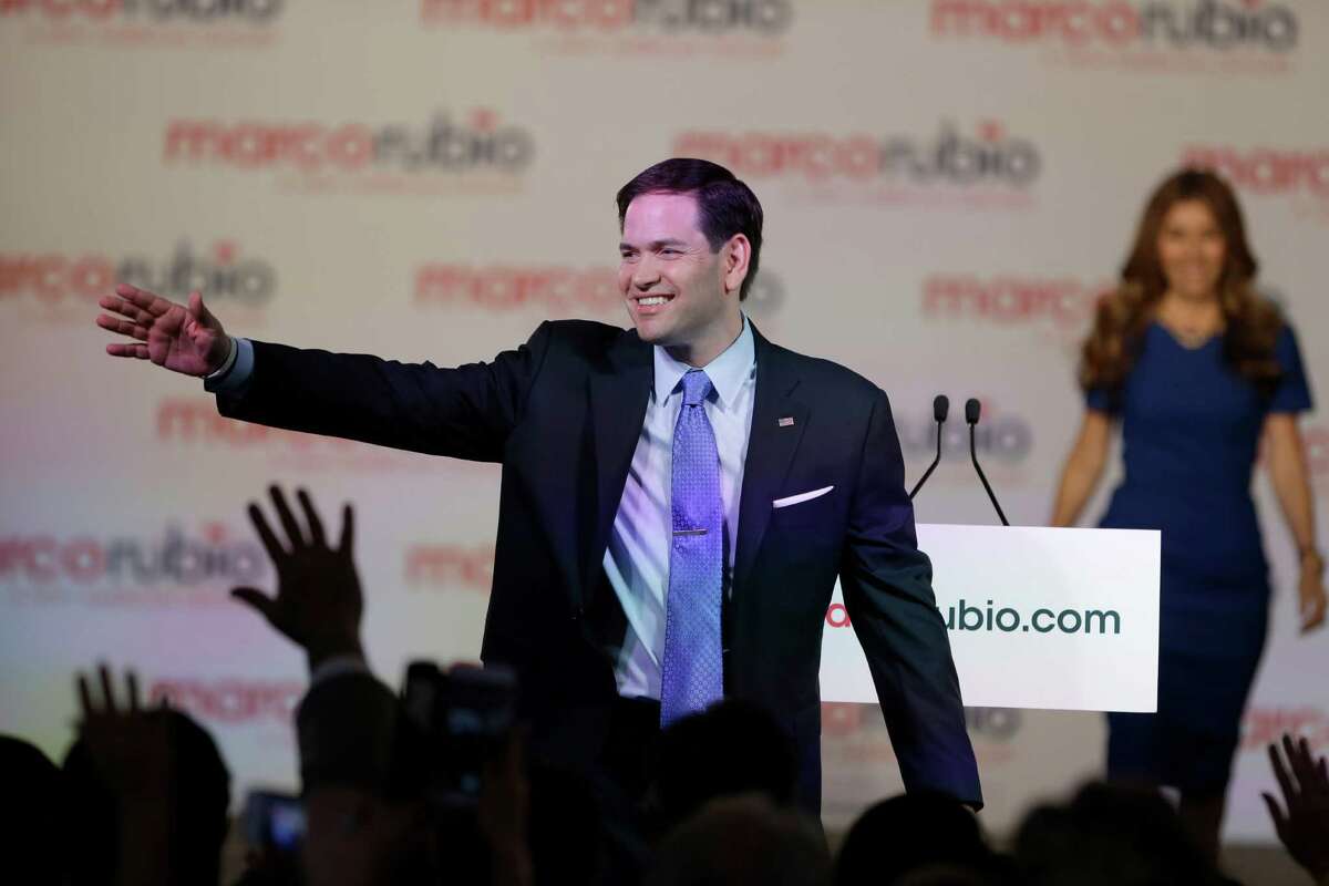 Florida Sen. Marco Rubio waves to supporters as his wife Jeanette joins him on stage, after he announced that he will be running for the Republican presidential nomination, during a rally at the Freedom Tower Monday.