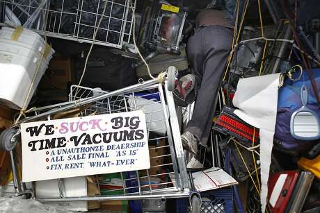 Searching and Oreck upright, vacuum cleaner collector Leonard Low digs through his storage unit in San Francisco, Calif. Low says he has 75-80 vacuum cleaners that he has restored and repaired from the ground up.