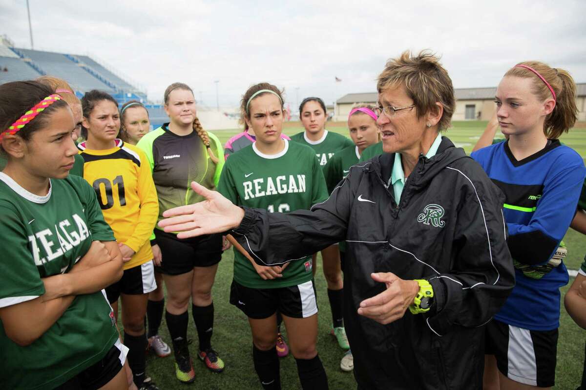 San Antonio Reagan head coach Frankie Whitlock, right, talks to the team before their 6A semi-final match against Coppell. Reagan lost to Coppell 0-1 during the 6A Girls Soccer Semi-Final in Georgetown on Friday April 17, 2015. Julia Robinson/For the Express-News